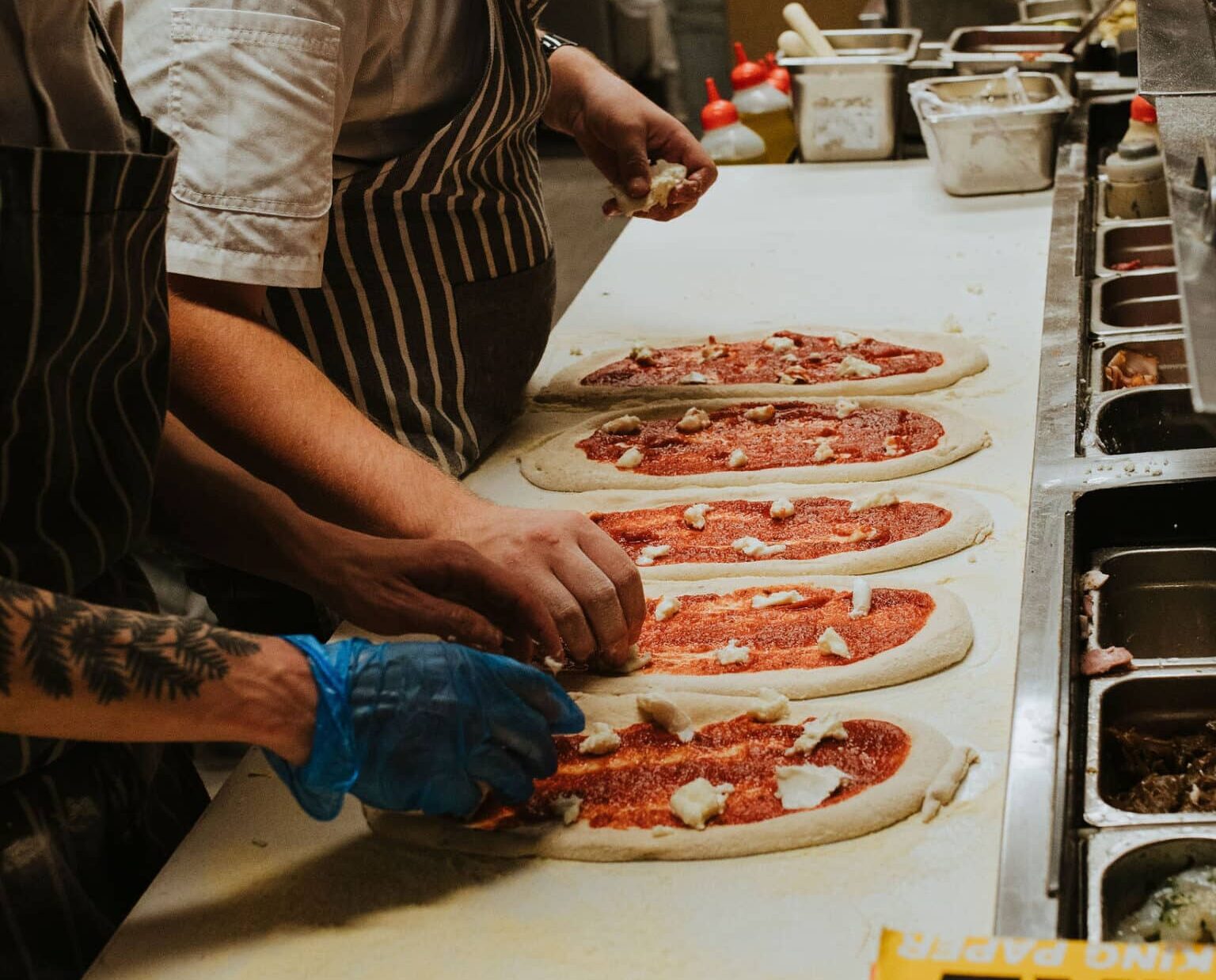 Chefs preparing wood-fired pizza at Factory 51 — Italian restaurant Brisbane