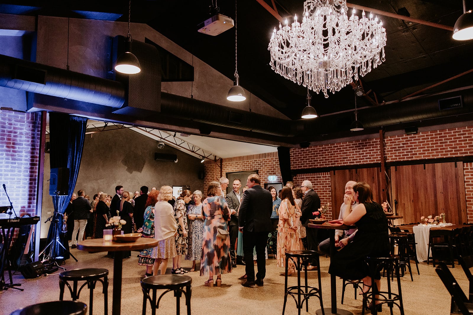 Ellen and Justin Cocktail Wedding Reception at Factory51 Guests mingling under the chandelier at Ellen and Justin’s Factory51 wedding reception