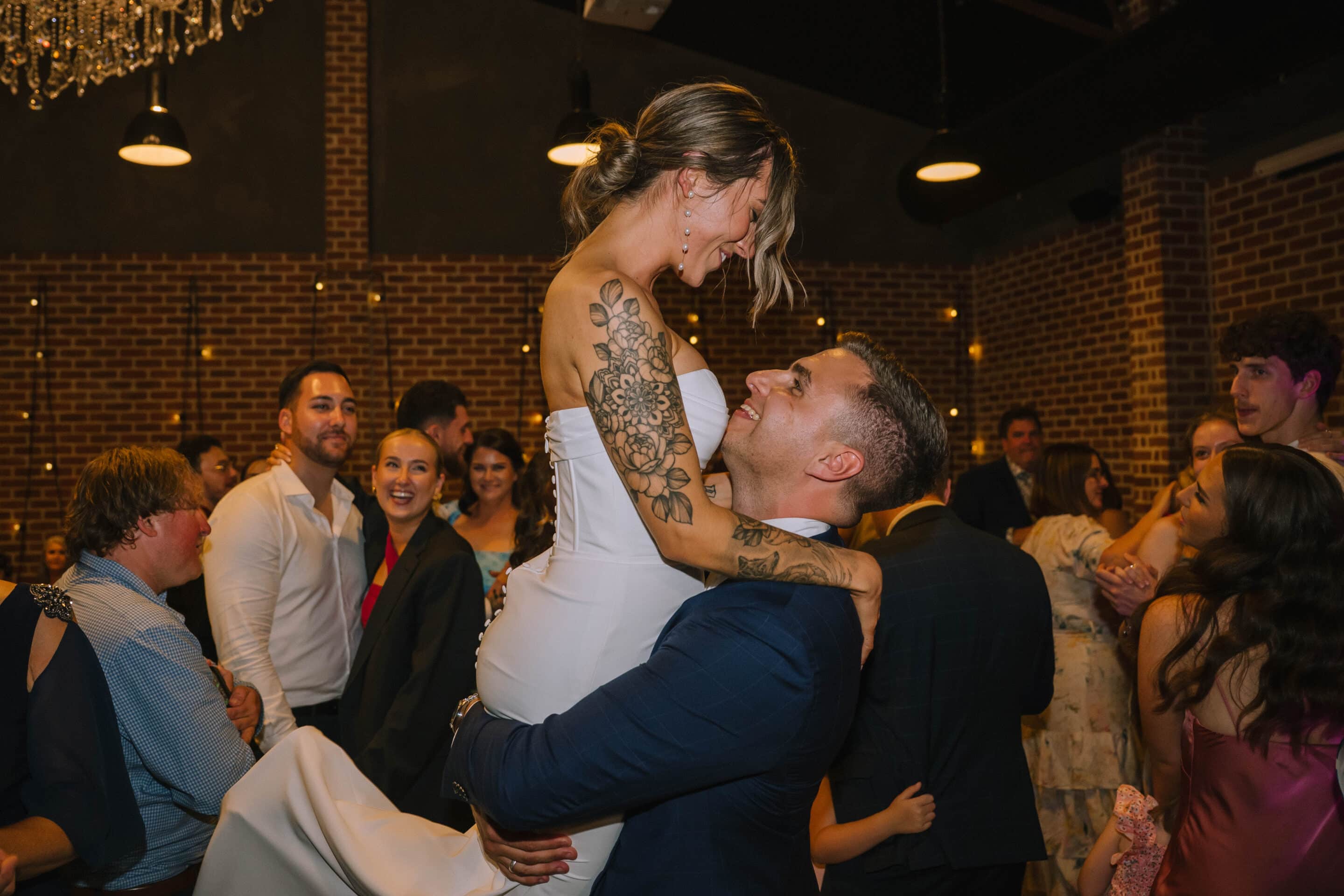 Indi and Jeremy celebrating on the dance floor at their Factory51 wedding reception