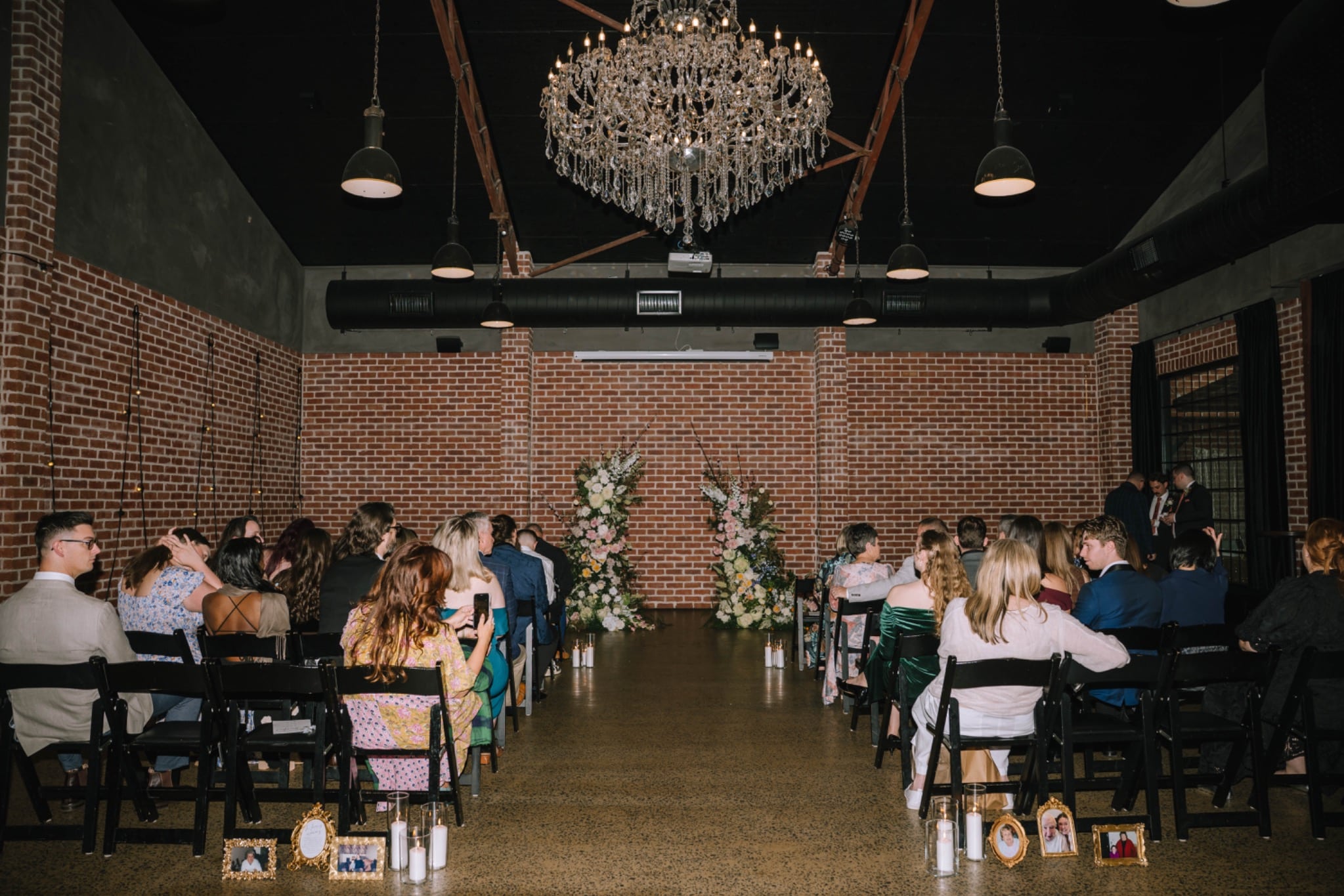 Teagan and Micheal’s wedding ceremony under the chandelier at Factory51