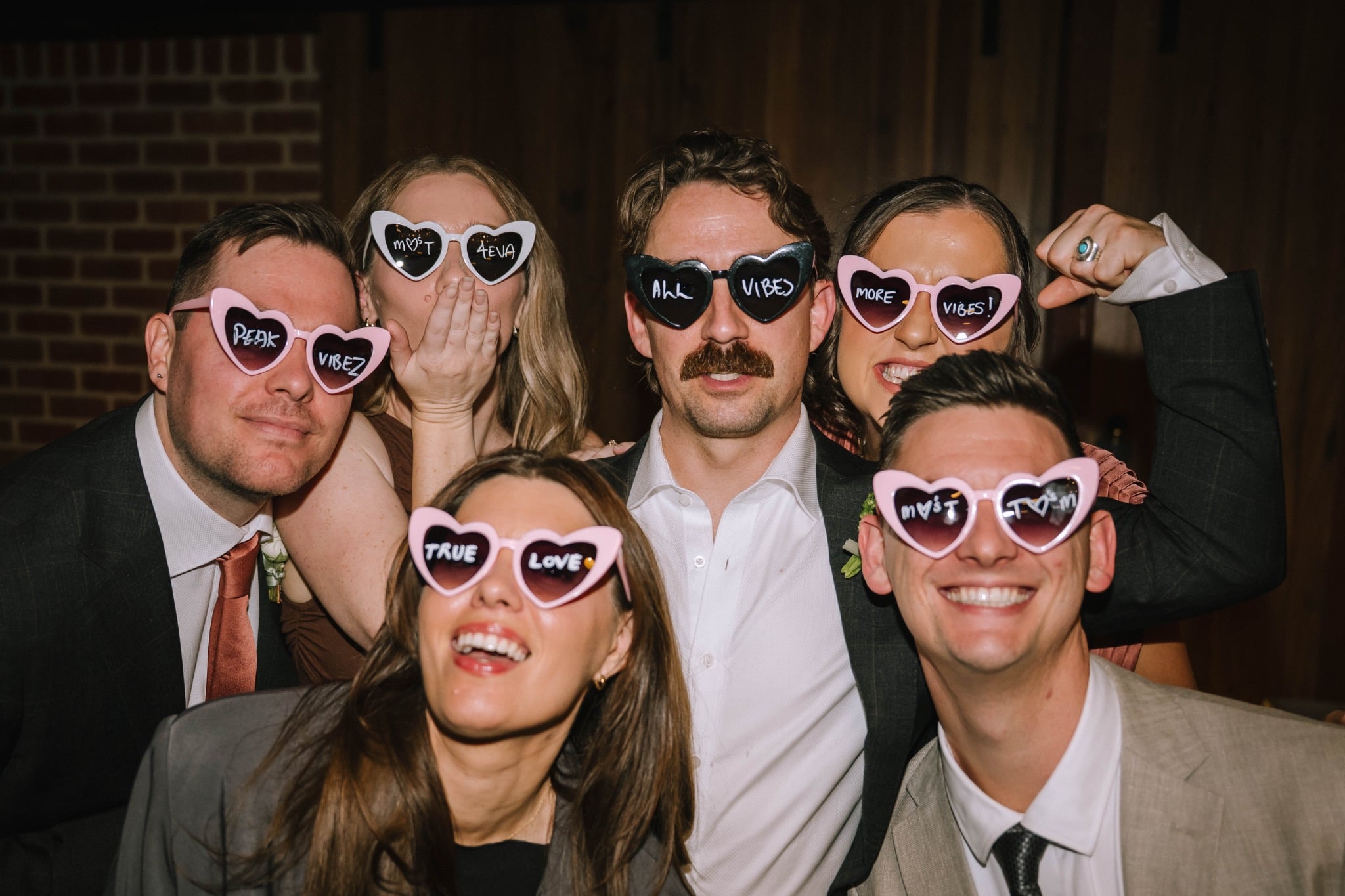 Teagan and Micheal’s wedding guests wearing fun sunglasses at Factory51